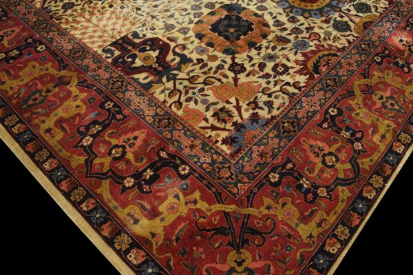 Close-up detail of a rug corner showing a beige floral field meeting a wide rust red patterned border.
