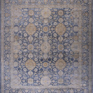 Ornate traditional rug featuring a dense floral pattern in blue, washed beige, and subtle gold tones.