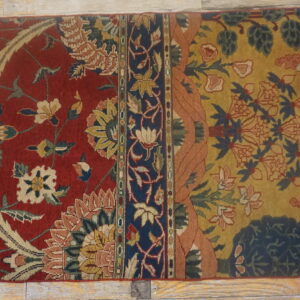 Ornate runner rug with contrasting red and mustard yellow fields separated by a navy floral border.