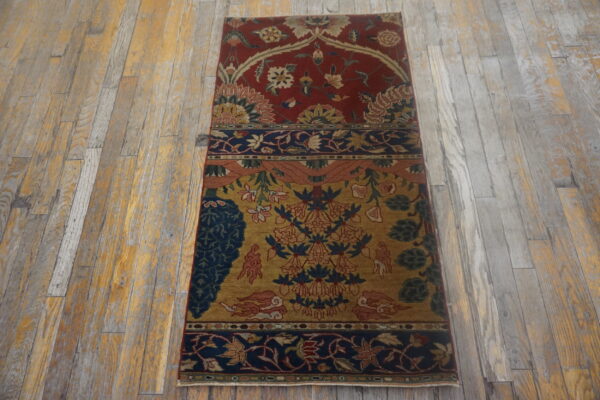 Red, gold, and blue paneled traditional runner rug displayed on distressed light wood floors.