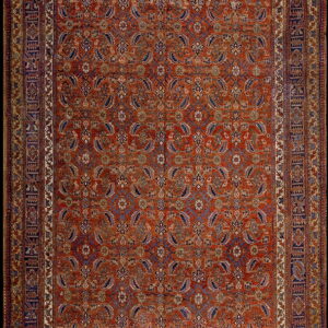 Rust-colored rug with a dense blue and ivory paisley motif and complex multi-layered borders.