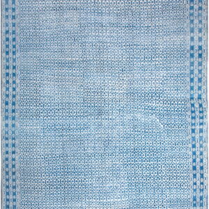 Distressed blue and white rug with an allover quatrefoil repeating pattern and multi-layered geometric borders.