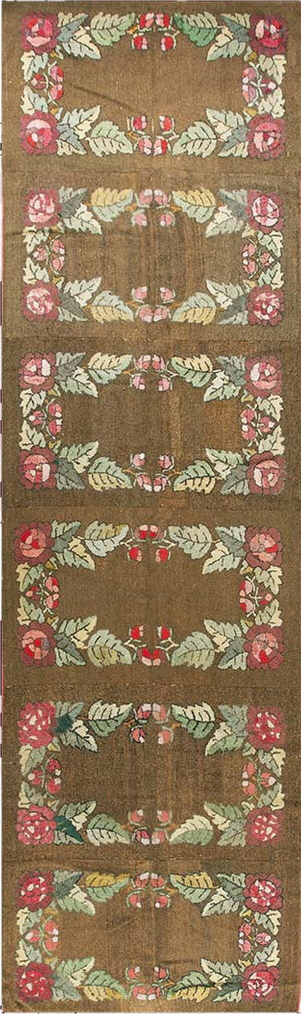 Dark brown runner rug featuring repeated rose and leaf wreath motifs in pink and green.