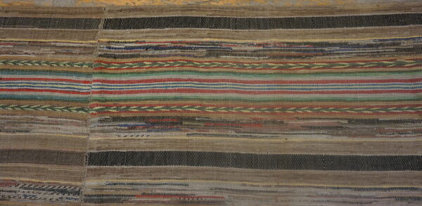 Textured flatweave rug with dominant brown and black stripes punctuated by thin bands of red, blue, and green.