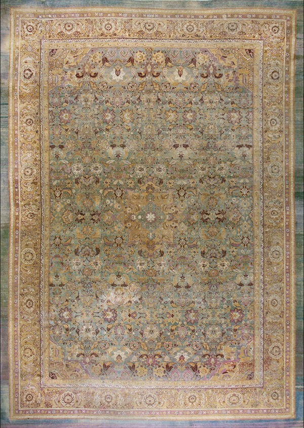 Sage green and gold traditional rug with an intricate floral pattern and wide ornamental borders.