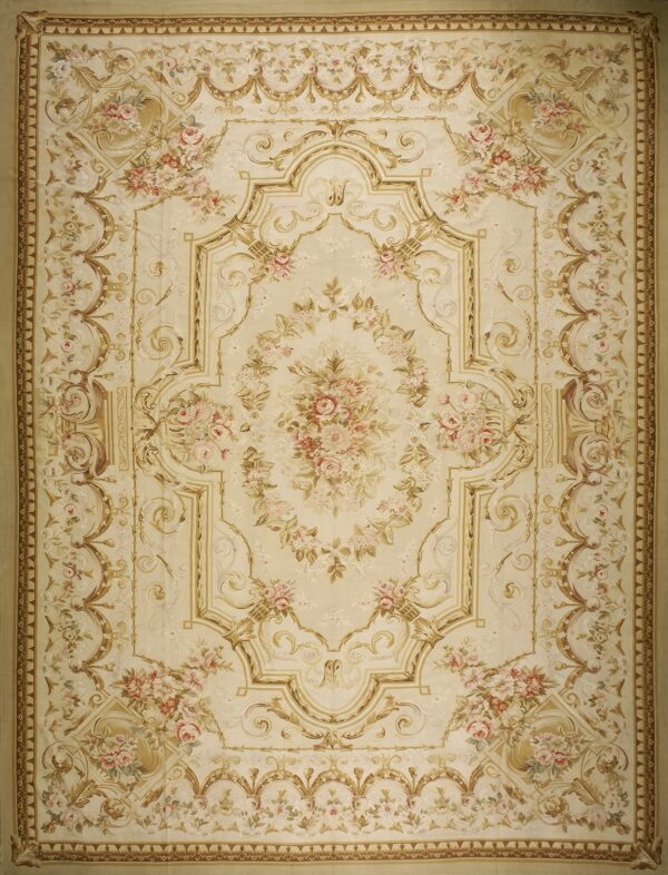 Cream rug featuring a large pink floral bouquet surrounded by elaborate tan and gold scrolling borders.