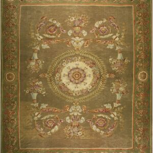 Ornate traditional rug with an olive-khaki field, a sage floral border, and central medallion motifs.