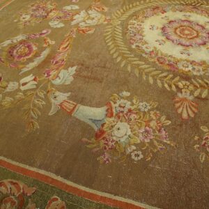Flatwoven rug in shades of brown and gold, featuring an elaborate central floral medallion and border.
