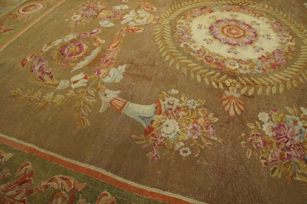 Flatwoven rug in shades of brown and gold, featuring an elaborate central floral medallion and border.