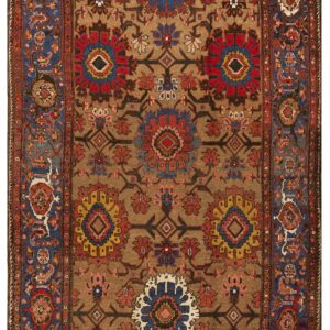 Brown rug with elaborate floral and geometric medallions in red, blue, and yellow, framed by blue borders.