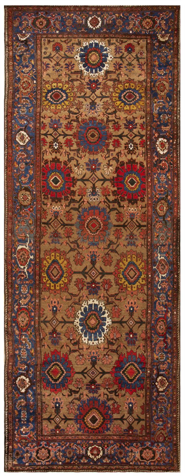 Brown rug with elaborate floral and geometric medallions in red, blue, and yellow, framed by blue borders.