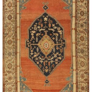 Low-pile rust rug with a geometric navy medallion, light blue spandrels, and complex floral beige border.