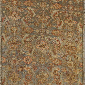 Full view of a distressed runner rug with an intricate traditional pattern in dusty blue, rust, and tan.