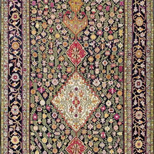 A dark runner rug with a dense floral pattern and alternating magenta and cream geometric center medallions.