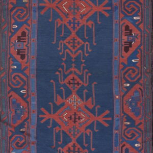 Deep indigo runner rug with repeating rust red geometric tribal designs and thick patterned borders.