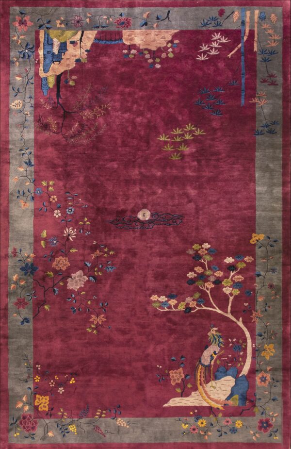 Saturated magenta rug featuring a gray border and complex floral and scenic avian patterns.