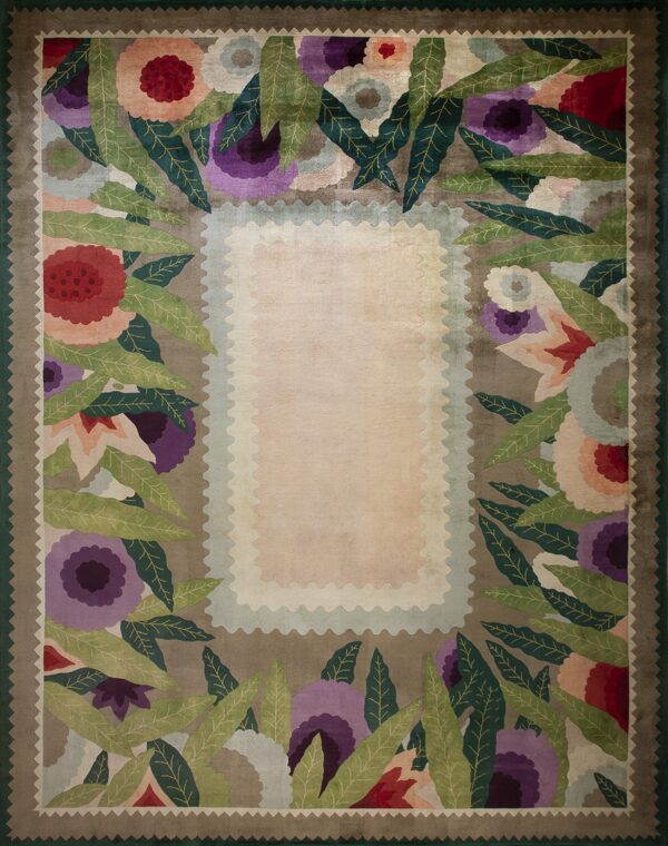 Multicolor rug featuring stylized flowers and leaves bordering a plush rectangular light pink center.
