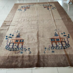 Low-pile beige rug featuring four colorful pagoda designs and vines, set on light cream square tile.