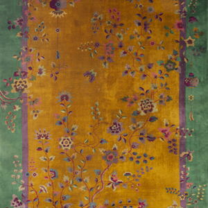 Golden yellow rug with detailed pink and purple floral vines and a wide green decorative border.