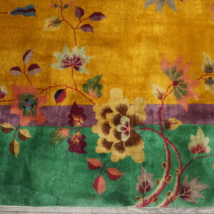 Golden yellow high-pile rug featuring a dense floral pattern with contrasting green and purple border stripes.