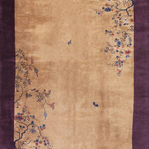 Deep purple border and tan field rug with scattered floral vines, grapes, and butterflies.