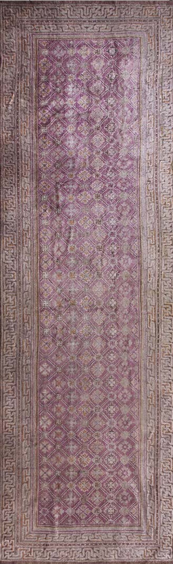 Muted purple runner rug with a low pile geometric lattice pattern and complex grey scroll borders.