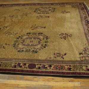 Large, tan high-pile rug with geometric and multicolor floral patterns on rustic wood floors.