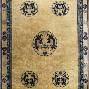 Golden yellow rug featuring a subtle fret background and five contrasting circular dark blue dragon motifs.