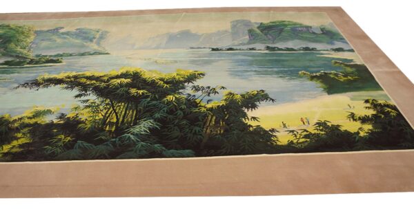 Detailed scenic rug showing green bamboo, blue water, distant mountains, and a wide tan border.