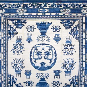 Blue and white pictorial rug featuring a detailed central dragon medallion and intricate stepped borders.