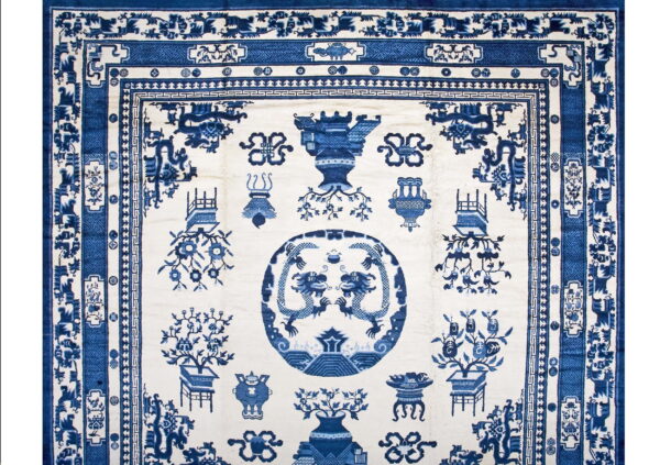 White field rug with detailed blue chinoiserie pattern, twin dragon medallion, and extensive border design.