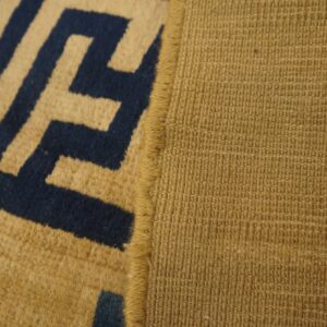 High-pile tan and navy Greek key pattern meets a tight woven tan backing with thin blue stripes.