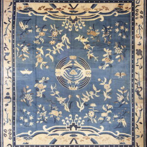 Light blue rug with extensive cream and tan botanical and avian motifs and a wide border.