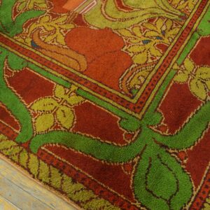 High-pile rug in rust, green, and yellow botanical patterns rests on distressed wooden floorboards.