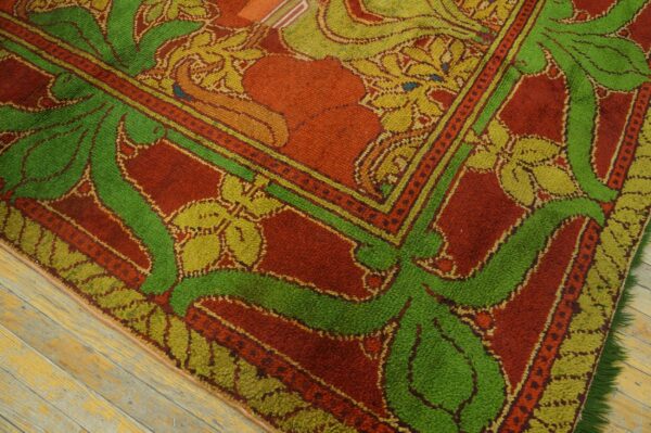 High-pile rug in rust, green, and yellow botanical patterns rests on distressed wooden floorboards.