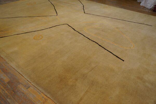 Vintage large size modernist mid century modern ecuadorian art rug 3 Golden low-pile rug with abstract dark brown and yellow designs lies on worn plank wood flooring.