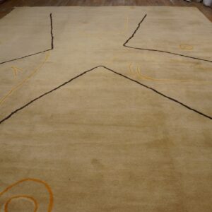 Tan medium-pile rug with abstract dark lines and yellow loops covers a wooden floor.