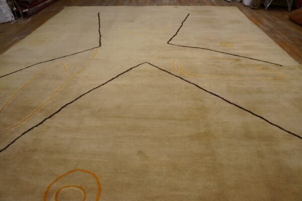 Vintage large size modernist mid century modern ecuadorian art rug 2 Tan medium-pile rug with abstract dark lines and yellow loops covers a wooden floor.