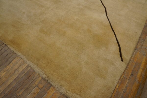 Vintage large size modernist mid century modern ecuadorian art rug 7 High-pile beige rug with a dark curving line resting on aged wooden floorboards.