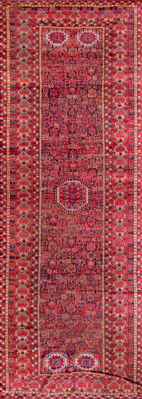 Vibrant red patterned antique knotted rug