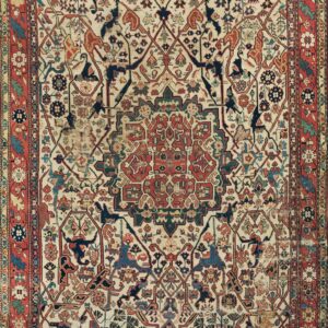 Ivory field rug featuring a complex geometric and stylized floral pattern in navy, rust, and teal with a red border.