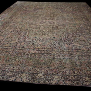 Traditional large area rug in faded pink, navy, and cream with complex floral medallion design.