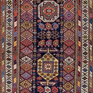 Geometric runner rug featuring stylized medallions on a dark blue ground, surrounded by complex red and cream borders.