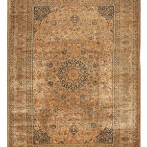 Ornate traditional rug with a large navy blue medallion set on a detailed gold-brown field.