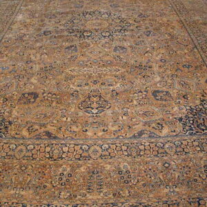 Low-pile rug in golden tan and navy blue with a detailed traditional floral medallion design.