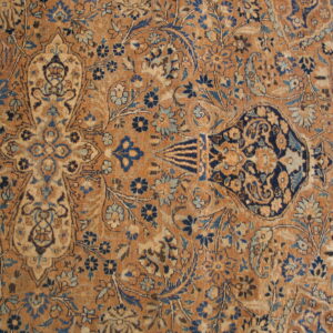 Tawny brown rug with dense traditional patterns woven in navy blue, light blue, and beige.