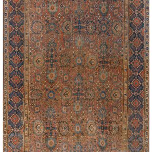 Muted rust and navy rug with low pile, featuring intricate geometric and stylized floral motifs.