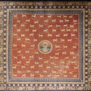 Red square rug featuring scattered tan deer, a central round design, and multi-layered blue and brown borders.