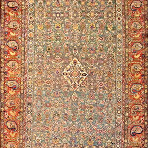 Ornate traditional rug with a muted sage field, intricate floral patterns, and bold rust paisley borders.