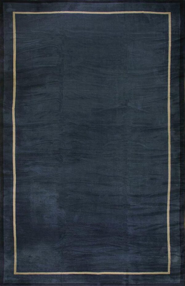 Navy area rug with a subtly textured dark field and a thin light beige rectangular border line.